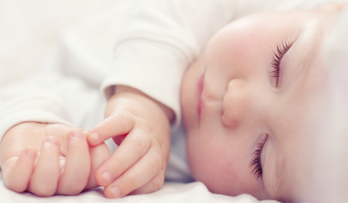 close-up portrait of a beautiful sleeping baby on white